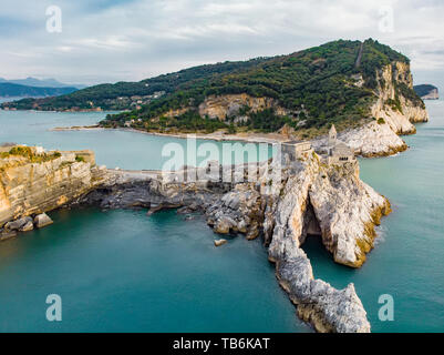 Beautiful aerial view of the Gothic-style Church of St. Peter (Chiesa di San Pietro) sitting atop a rocky headland in Porto Venere village on the Ligu Stock Photo