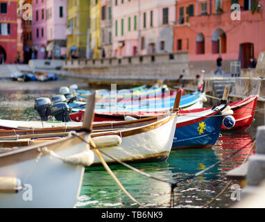 Colourful fishing boats in small marina of Vernazza, one of the five centuries-old villages of Cinque Terre, located on rugged northwest coast of Ital Stock Photo