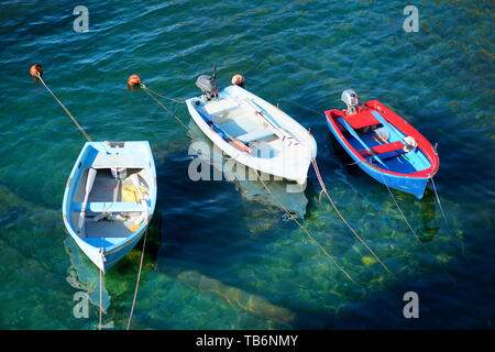 Colourful boats in tiny marina of Riomaggiore, the largest of the five centuries-old villages of Cinque Terre, located on rugged northwest coast of It Stock Photo