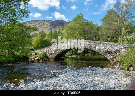 New Bridge the traditional stone built bridge over the River Derwent between Castle Crag and Rosthwaite, Borrowdale near Keswick, Cumbria, Lake Distri Stock Photo