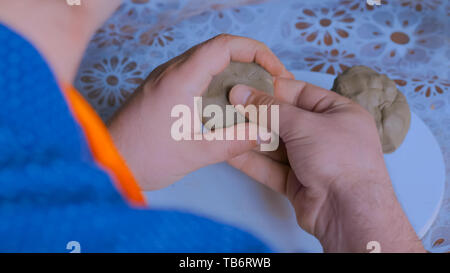 Man making mug in pottery studio workshop Stock Photo