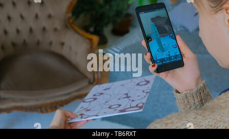 Woman using smartphone with augmented reality app Stock Photo