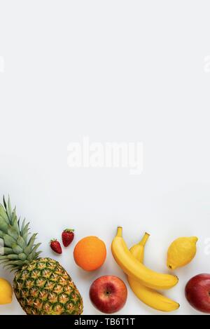 Top view of various fruits on a white background. Copy space. Stock Photo