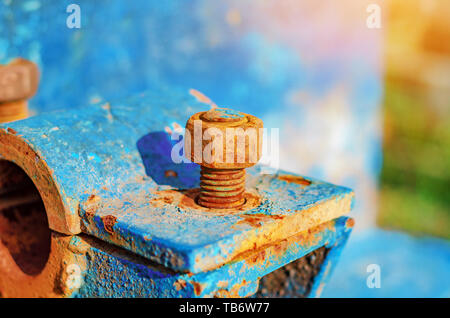 Rusty metal bolts and nuts on metal mounts. Abandoned equipment. Stock Photo