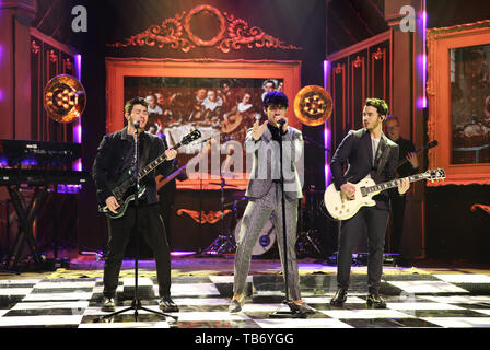 (left to right) Nick Jonas, Joe Jonas, and Kevin Jonas of the Jonas Brothers performing during the filming for the Graham Norton Show at BBC Studioworks 6 Television Centre, Wood Lane, London, to be aired on BBC One on Friday evening. Stock Photo