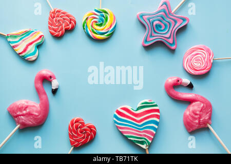 Set of rainbow colorful candy isolated on blue background. Top view. Copy space. Space for text. Stock Photo