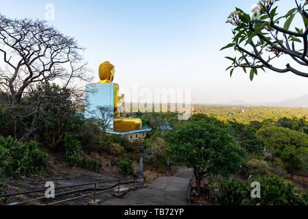 Dambulla, Sri Lanka - March 30, 2019: Golden temple with big Buddha statue near Dambulla cave temple complex in Sri Lanka Stock Photo