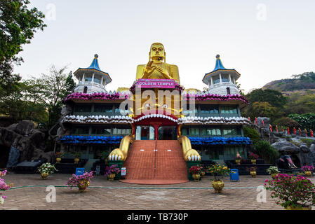 Dambulla, Sri Lanka - March 30, 2019: Golden temple with big Buddha statue near Dambulla cave temple complex in Sri Lanka Stock Photo