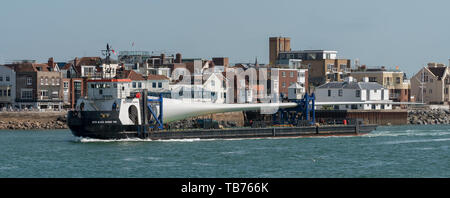 Portsmouth, England, UK. A deck cargo ship with a large wind turbine blade onboard. The MTB Blade Runner Two. Stock Photo