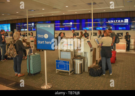 Orlando, Florida.  March 01, 2019. People using United Airlines Self service check-in at Orlando International Airport. Stock Photo