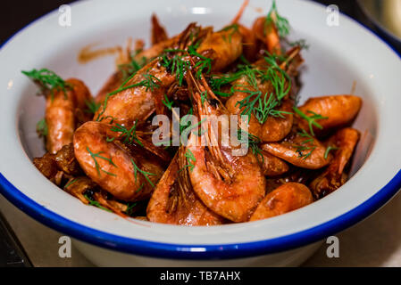 Prepared shrimps with dill in bowl on table close Stock Photo