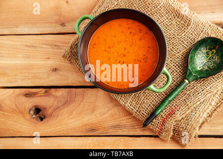 lentil soup in a soup plate on a canvas on a wooden background. top view Stock Photo