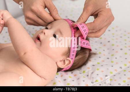 Pediatrician examining little baby in clinic Stock Photo