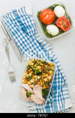 Delicious and healthy lunch. Chicken meat with boiled vegetables in container on grey background, close up. Healthy food, diet Stock Photo