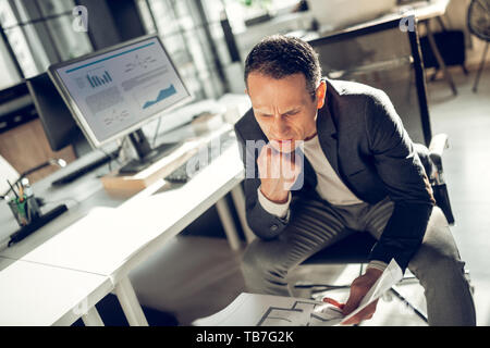 Businessman feeling overloaded having too much work Stock Photo