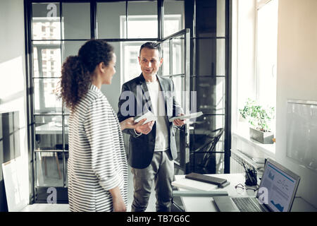 Interior designer consulting trainee telling her some information Stock Photo