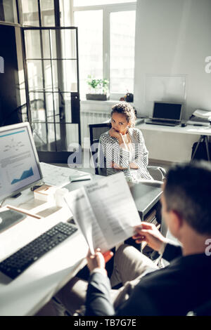 Young woman feeling uncomfortable during job interview Stock Photo