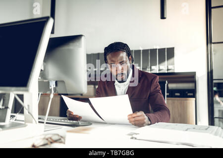 African-American young businessman reading the financial reports Stock Photo