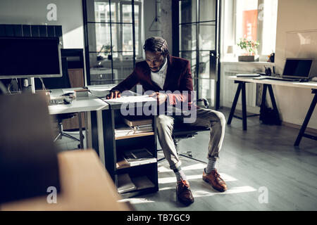 Businessman wearing striped socks feeling busy while working Stock Photo