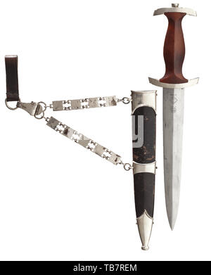 A service dagger M 36 with chain hanger, Blade with etched motto and double maker's etching 'RZM M7/27' and 'Puma Solingen', nickel-plated grip fittings, brown, wooden grip with inset aluminium eagle and enamelled SA emblem. Black lacquered steel scabbard (scratched) with nickel-plated iron fittings and iron chain hanger with largely preserved nickel plating. Hallmarked 'RZM 5/8' as well as 'NSKK-Musterschutz' on the reverse. Length 37.5 cm. historic, historical 20th century, Editorial-Use-Only Stock Photo