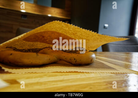 Pretzels in paper pack on wooden table. Stock Photo