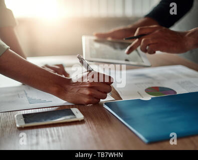 Business people's hand analyzing the graph in the office Stock Photo