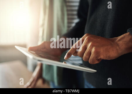 Close-up of a man touching on digital tablet Stock Photo