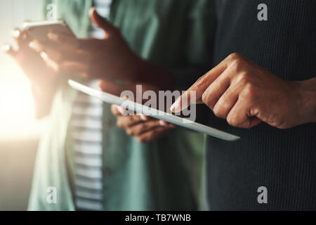 Woman and man hands with smartphone and tablet pc Stock Photo