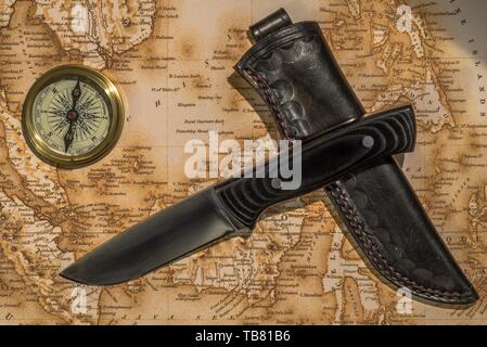 Background with map, knife and compass Stock Photo