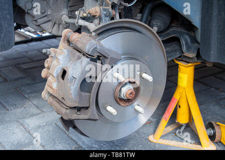 View of new brake discs and pads fitted to a car. Caliper installed Stock Photo