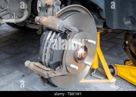 View of new brake discs and pads fitted to a car. Caliper removed Stock Photo