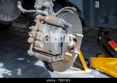 View of new brake discs and pads fitted to a car. Caliper installed Stock Photo