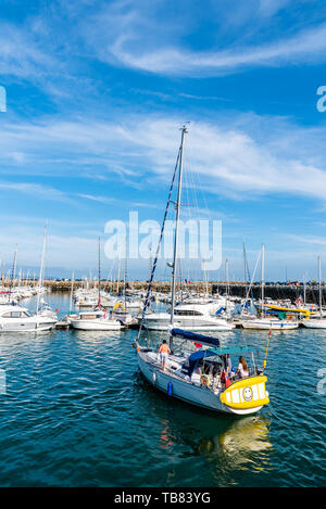 Morgat, France - August 4, 2018:  A yacht in the marina of Morgat a sunny day of summer with many smalls boats aligned in the piers Stock Photo