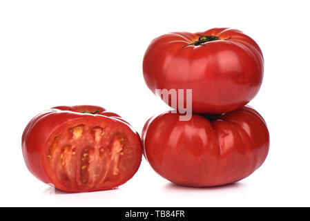 Three ripe big tomatoes with water drops isolated on white background.. Cut tomato. Close up. Copy space Stock Photo