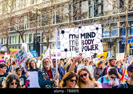 January 19, 2019 San Francisco / CA / USA - Participant to the Women's March event holds 'My body, my choice, my power' sign while marching on Market 