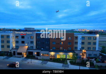 Night view of airport Hotels near Minneapolis-Saint Paul International airport with an airplane taking off in the background.Bloomington.Minnesota.USA Stock Photo