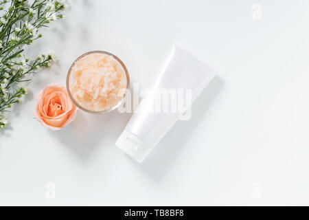 skin care concept. flat lays of skincare remedies style in white squeeze tube package with blank label and salt spa in glass bowl with natural materia Stock Photo