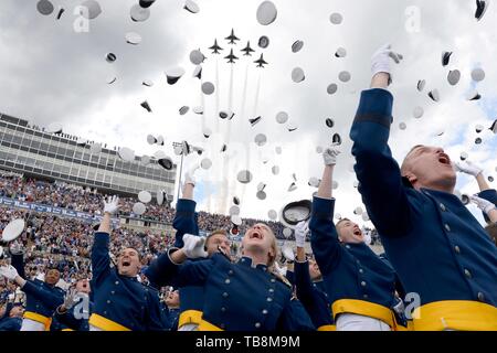 Colorado Springs, Colorado, USA. 30th May, 2019. U.S. Air Force Academy cadets celebrate by tossing their hats into the air as the Air Force Air Demonstration Squadron Thunderbirds fly overhead at the conclusion of graduation ceremonies at the USAF Academy Falcon Stadium May 30, 2019 in Colorado Springs, Colorado. U.S. President Donald Trump gave the commencement address to the more than 900 graduates. Credit: Planetpix/Alamy Live News Stock Photo