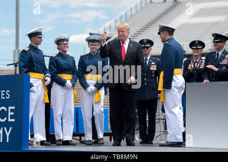 Colorado Springs, Colorado, USA. 30th May, 2019. U.S President Donald Trump holds up a challenge coin presented to him by cadets during the U.S. Air Force Academy Graduation Ceremony at the USAF Academy Falcon Stadium May 30, 2019 in Colorado Springs, Colorado. Credit: Planetpix/Alamy Live News Stock Photo