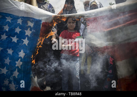 May 31, 2019, Tehran, Iran:  Iranians burn a US flag, during an anti-Israel rally marking Al Quds Day (Jerusalem Day), in support of Palestinian resistance against Israeli in Tehran, Iran. Each year Iran marks the last Friday of the fasting month of Ramadan as a solidarity day with the Palestinians. (Credit Image: © Rouzbeh Fouladi/ZUMA Wire) Stock Photo