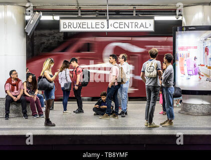 Passengers waiting on an underground platform in Brussels central station as a Thalys high-speed train is passing by. Stock Photo