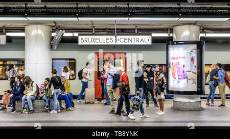 Passengers waiting on an underground platform in Brussels central station as an InterCity train is stopping. Stock Photo