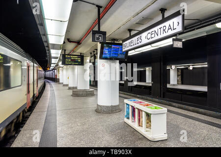 An InterCity train is leaving an empty underground platform in Brussels central station. Stock Photo