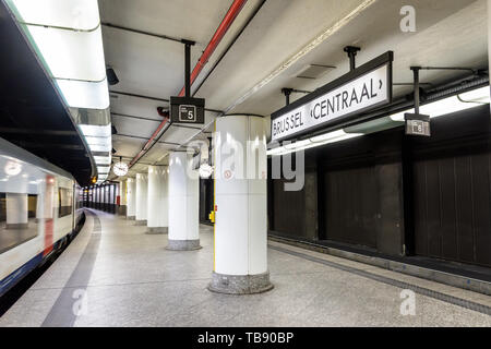 An InterCity train is leaving an empty underground platform in Brussels central station. Stock Photo