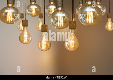 burning retro light bulb on blurred background colorful vintage design Stock Photo