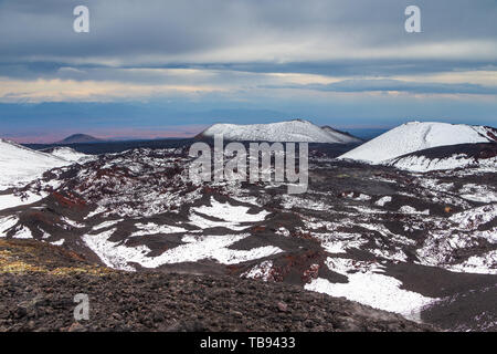 Volcanic landscape, massive, one of the volcanic complex on the Kamchatka Peninsula in the far east of Russia. Mountains covered with snow. Stock Photo