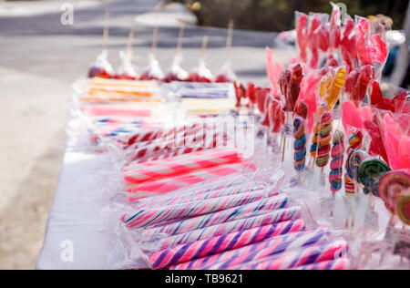 Close-up of colorful sugar sticks, sweet temptation in bright, fresh colors, sugary aromas, on a street market. Stock Photo
