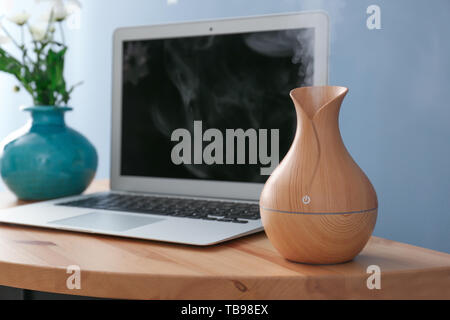 Aroma oil diffuser on table in room Stock Photo