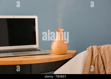 Aroma oil diffuser on table in room Stock Photo