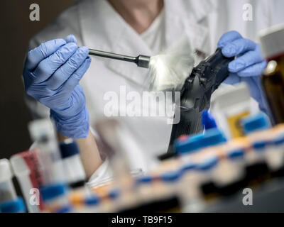 Expert Police takes samples in scientific laboratory, conceptual image Stock Photo